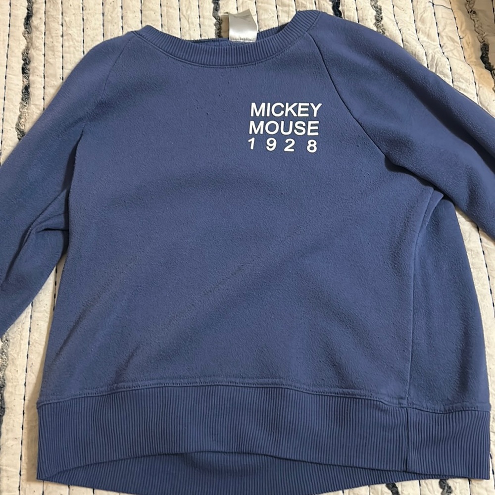 This is a Large, blue Disney sweater for girls